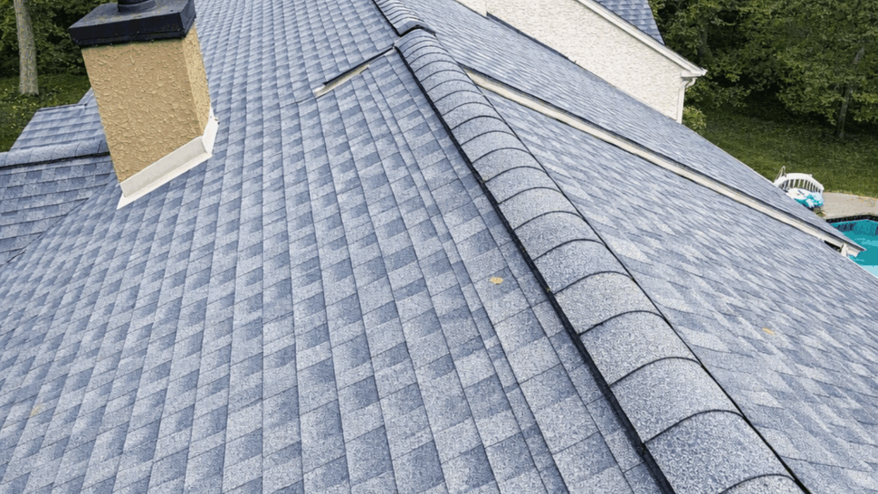 Roof ridge and chimneys on blue shingles | Tycos Roofing And Siding Inc Close overhead view of roof ridge, chimneys, and blue shingles.