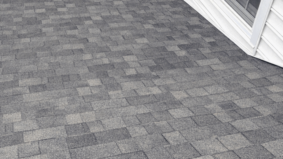Roof flashing at window junction | Tycos Roofing And Siding Inc Shingled roof meeting wall with flashing near a second-story window