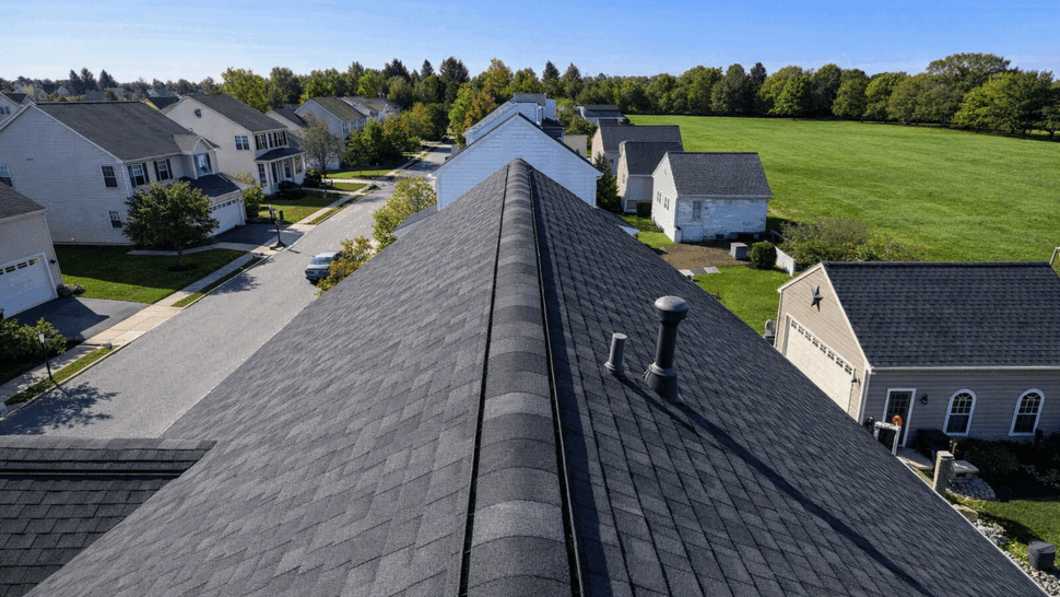 Aerial view of ridge roof installation | Tycos Roofing And Siding Inc Aerial view along the ridge of a dark shingle residential roof