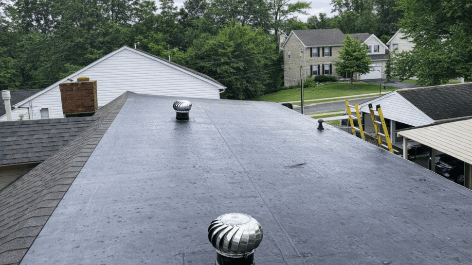 Flat Rubber Roof with Turbine Vents | Tycos Roofing And Siding Inc Flat rubber roof with multiple turbine vents and ladder at edge
