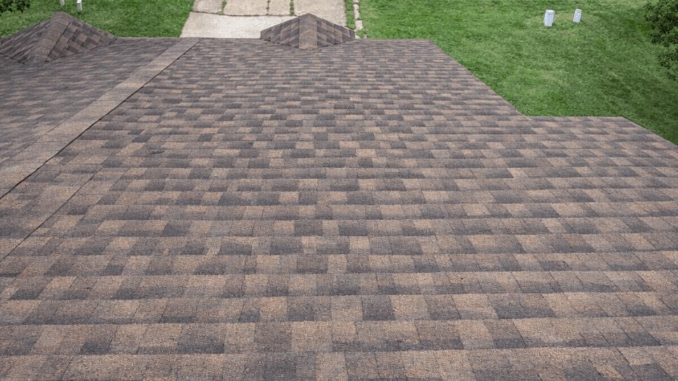 Close view of weathered asphalt shingles on a residential roof