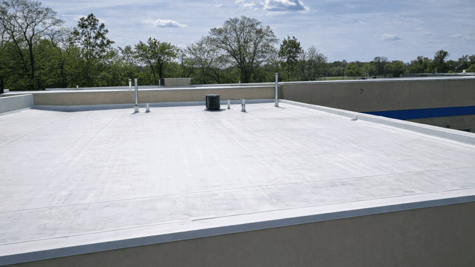 Close-up of flat roof with parapet wall and rooftop vents