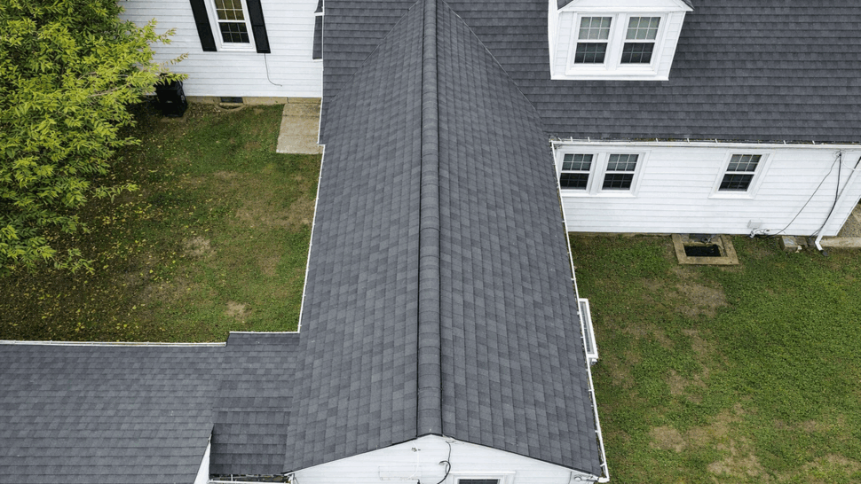 Top-down view of roof ridge and adjoining roof sections near a dormer.