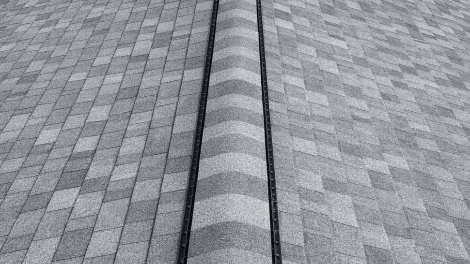 Roof Ridge Vent and Shingles | Tycos Roofing And Siding Inc Close-up of gray asphalt shingles and a black ridge vent on a peaked roof