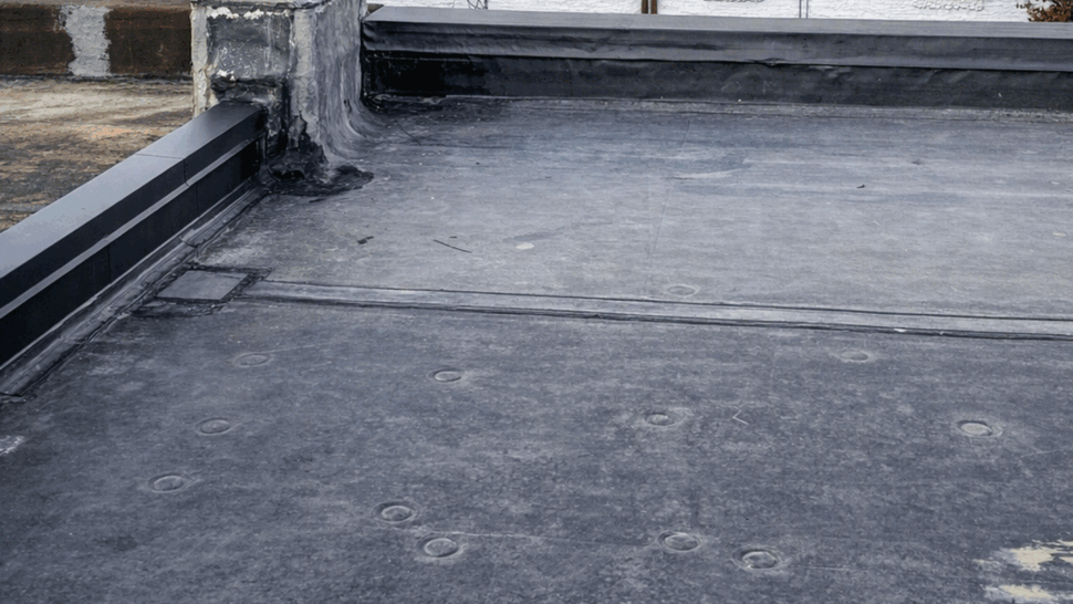 Flat Roof Parapet Overview | Tycos Roofing And Siding Inc Overview of flat roof and parapet with surrounding buildings