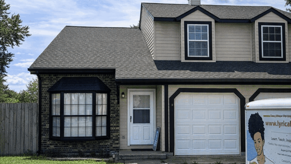 Suburban home with gray shingle roof and dark trim