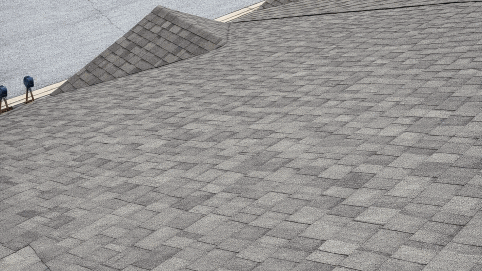 Aerial gray shingle roof | Tycos Roofing And Siding Inc Aerial view of a large gray asphalt shingle roof over a residential street