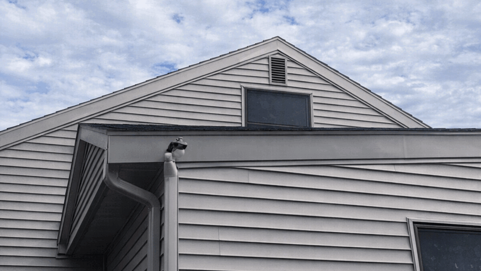 Close-up of gutter and downspout running along the roofline.