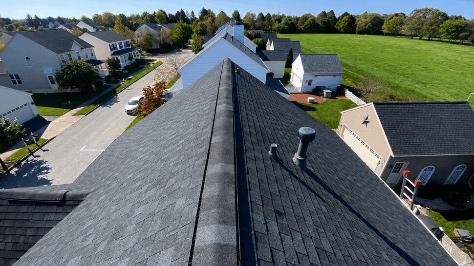 Aerial view along the ridge of a dark shingle residential roof