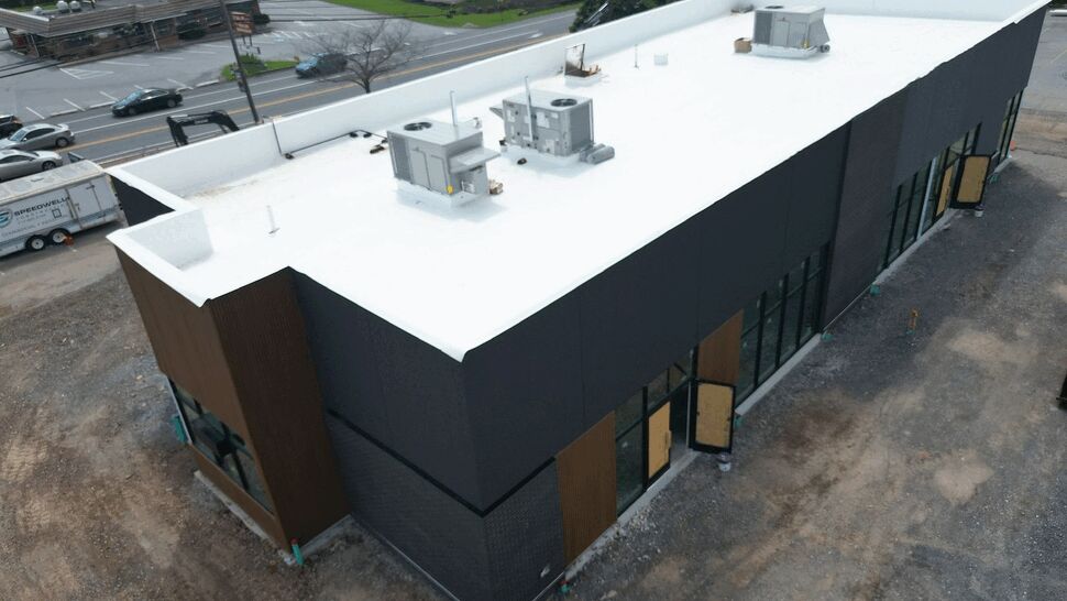 Aerial view of a white flat commercial roof with HVAC units