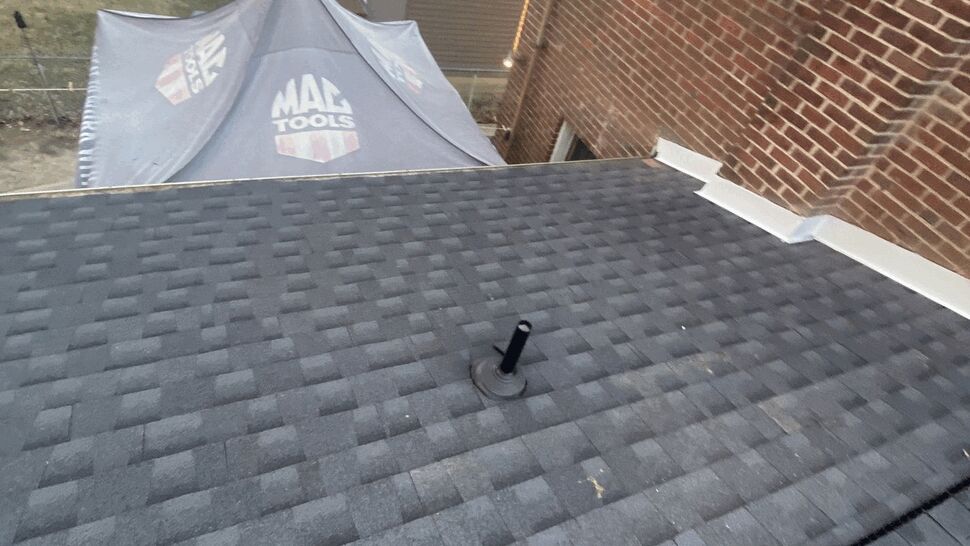 Close-up of asphalt shingle roof with a plumbing vent pipe