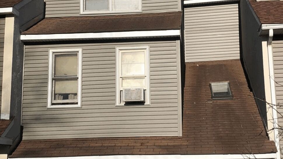 Rear deck with sliding glass door, railing, and a barbecue grill.