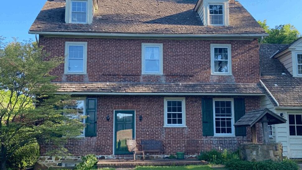 Rear Elevation Dormer Restoration | Tycos Roofing And Siding Inc Rear elevation with dormers and cedar-style roofing above a brick facade