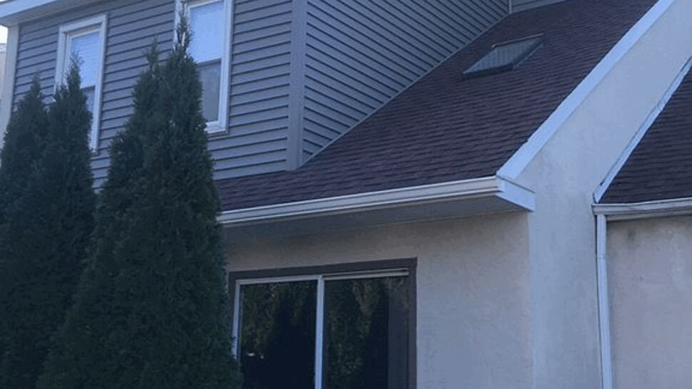 Back Deck with Siding and Roof | Tycos Roofing And Siding Inc Rear deck with sliding door, gray siding and brown roof