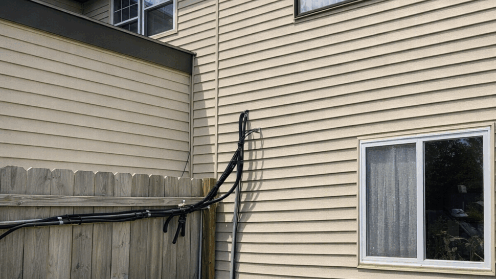 Residential siding with windows and an outdoor air conditioning unit