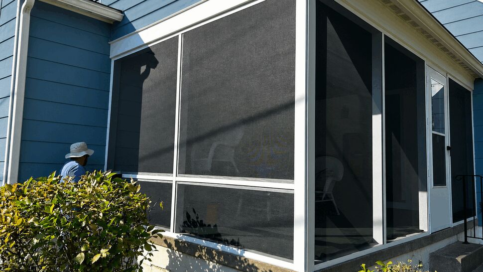 Blue Screened Room | Tycos Roofing And Siding Inc Blue home with a bright screened room and white trim