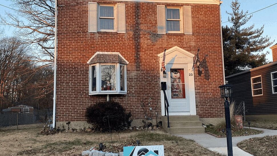 Brick two-story home with a Tycos sign on the front lawn