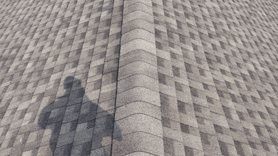 Patterned Shingle Ridge Roof | Tycos Roofing And Siding Inc Aerial close-up of a shingled roof ridge with patterned asphalt shingles.