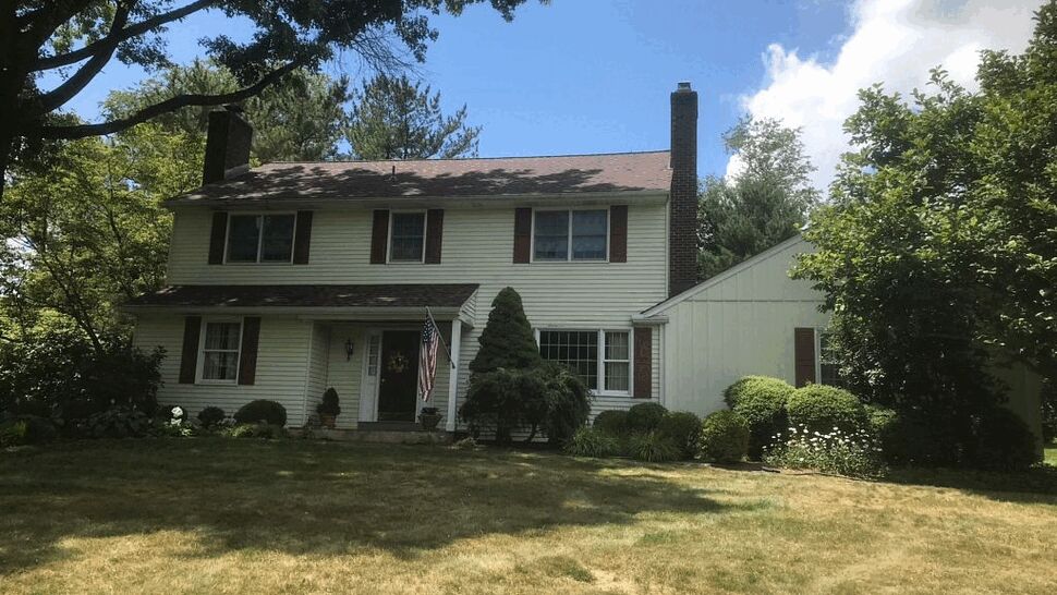 Front Two-Story Home with Roof and Siding | Tycos Roofing And Siding Inc Front view of two-story home with pitched roof, siding and front lawn.