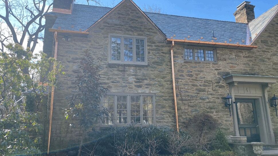 Close view of copper gutters on a stone house facade