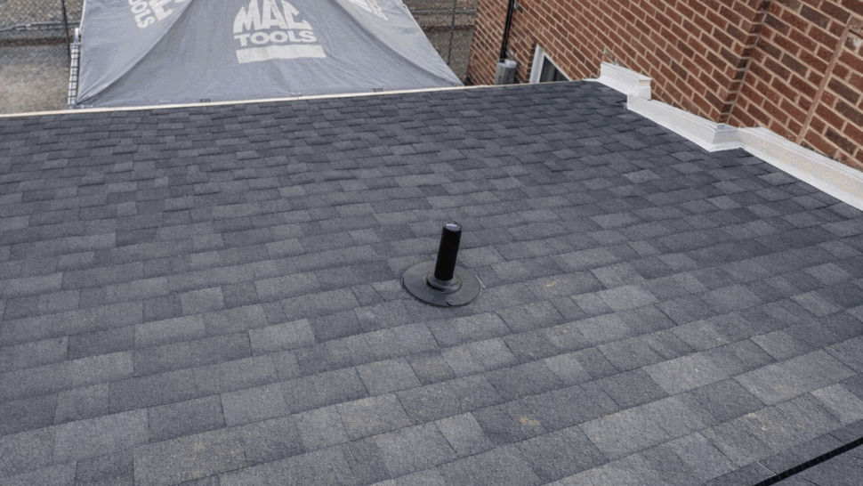 Close-up of asphalt shingle roof with a plumbing vent pipe