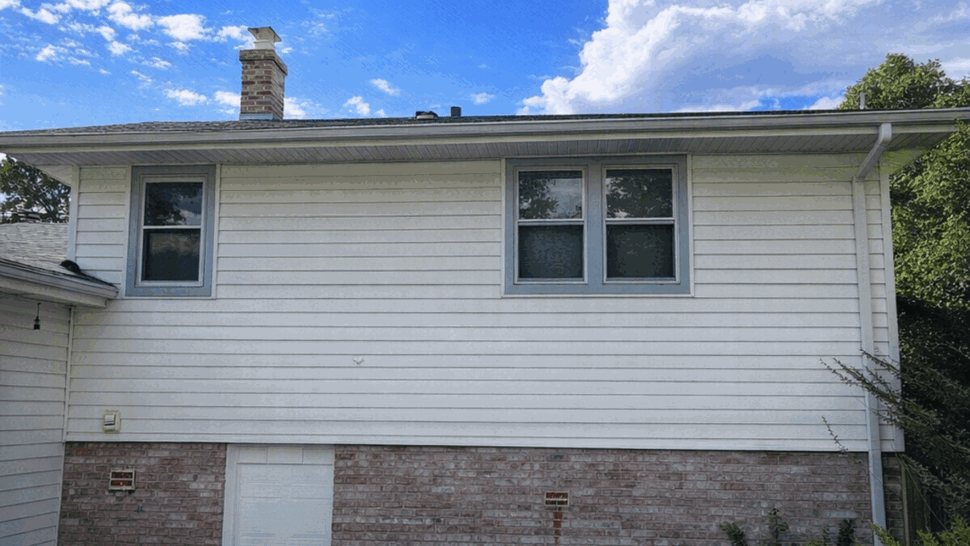 White Siding Exterior View | Tycos Roofing And Siding Inc Side of house with white siding, windows and blue painted deck