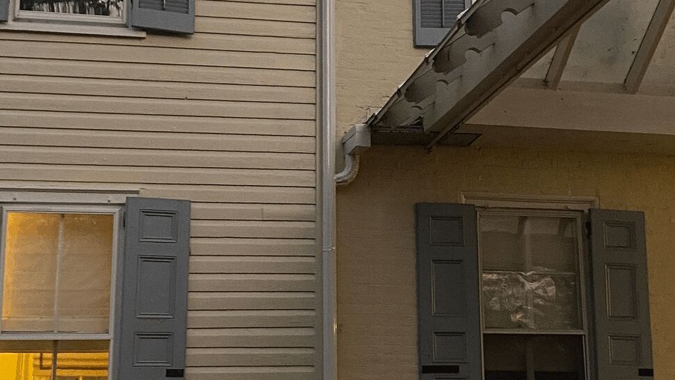 Two exterior wall styles showing vinyl siding and painted brick with gray shutters