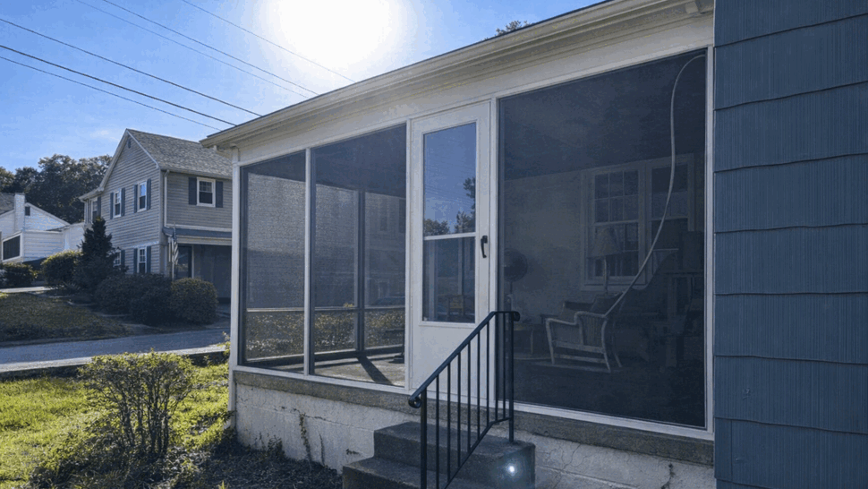 Screened Room Side View | Tycos Roofing And Siding Inc Side view of a screened room with steps, railings, and bright exterior