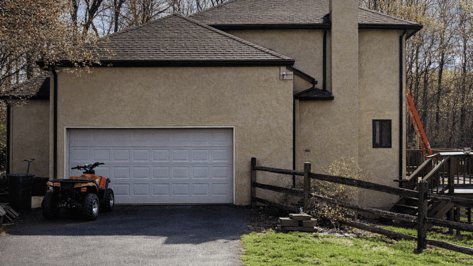 Side of house and garage showing roofline and gutters