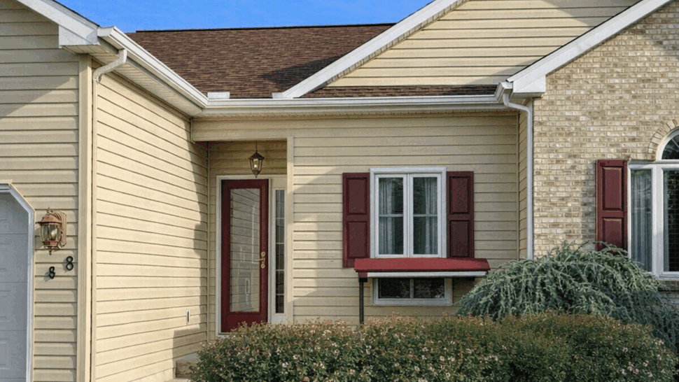 Beige Front Entry with Decorative Door | Tycos Roofing And Siding Inc Front beige house entry with decorative glass door and red shutters