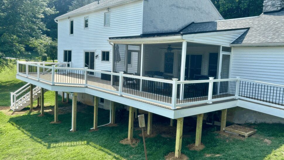 Elevated deck with screened porch | Tycos Roofing And Siding Inc Large elevated deck with white railing and attached screened porch