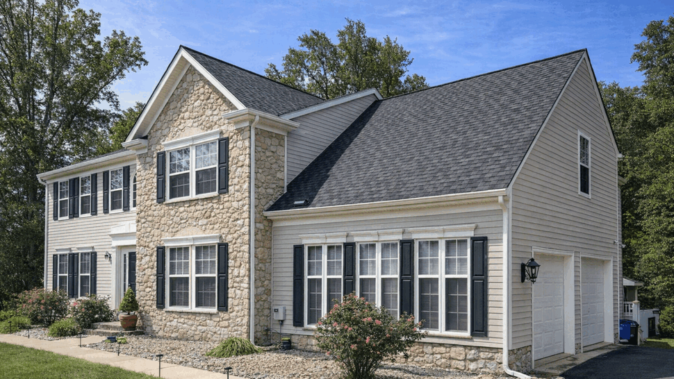 Angled front view with rooflines | Tycos Roofing And Siding Inc Angled front view of home with multiple rooflines, vinyl siding and attached garage.
