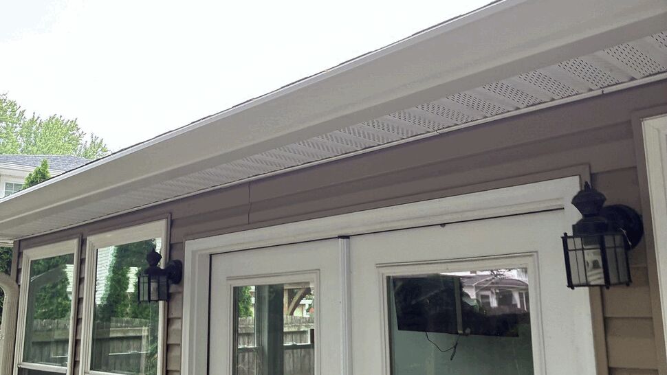 Four season room doors and trim | Tycos Roofing And Siding Inc French doors opening to a four season room with windows and exterior lights