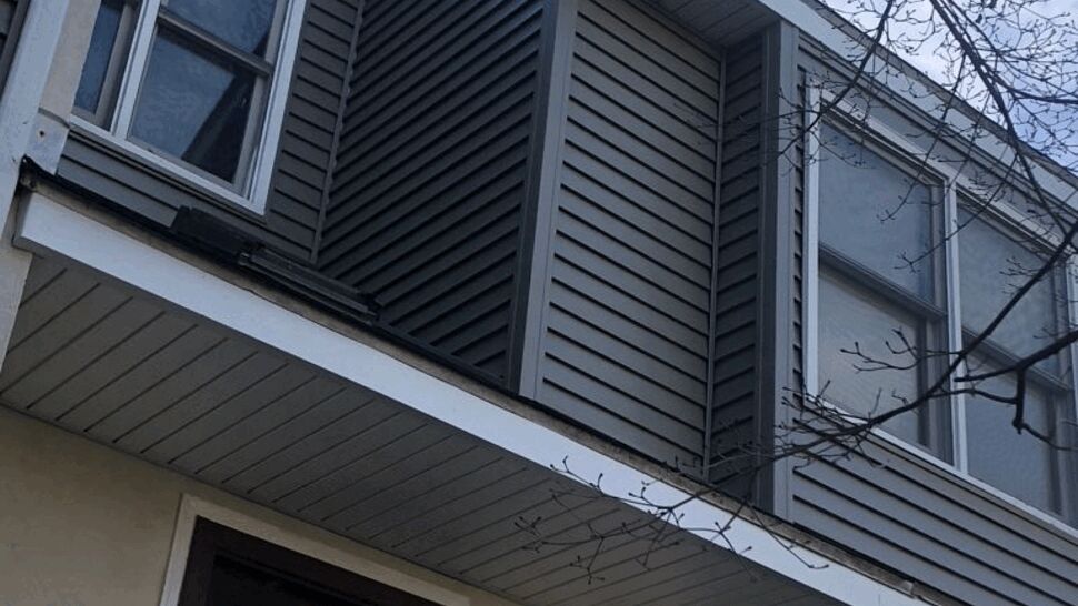 Front Entry Door and Soffit | Tycos Roofing And Siding Inc Front entry showing door, illuminated porch light, soffit, and address plaque.