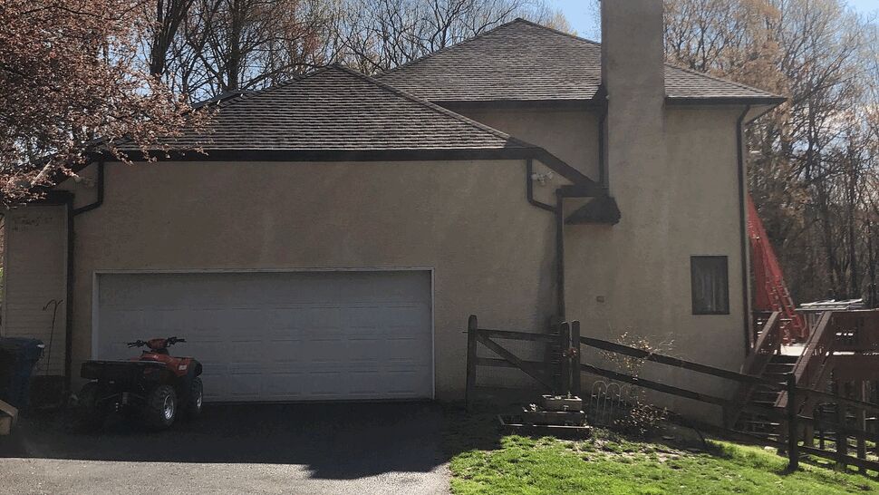 Side of house and garage showing roofline and gutters