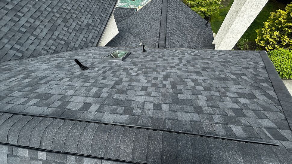 High roof slope with skylight, roof vents and new asphalt shingles