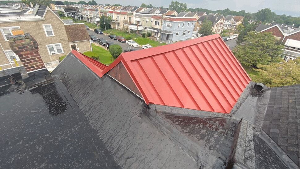 Red Metal Dormer and Roof Valley | Tycos Roofing And Siding Inc Red metal dormer and sealed roof valley with surrounding houses