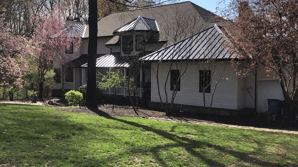 Front view of house with metal accent roofs and shingle main roof