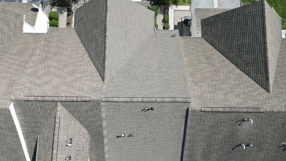 Top-down view of multiple connected townhouse roofs and ridges