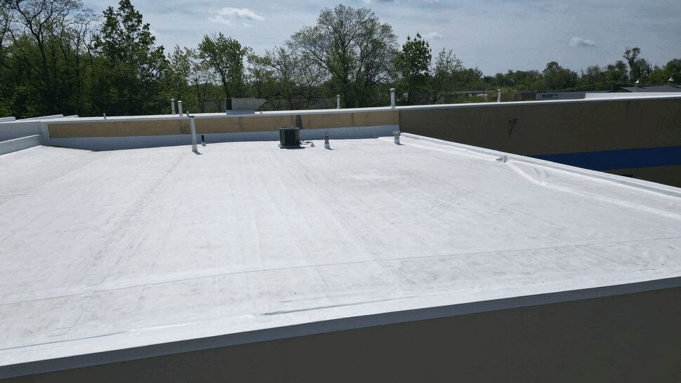 Close-up of flat roof with parapet wall and rooftop vents
