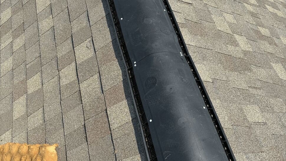 Ridge Vent Close-up | Tycos Roofing And Siding Inc Close-up of a black ridge vent installed along asphalt shingles