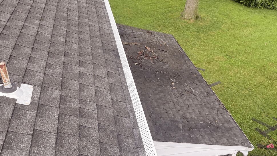 Roof above four season room and deck | Tycos Roofing And Siding Inc Shingle roof edge above a screened four-season room and small deck