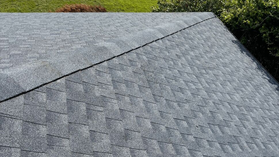 Top view of residential shingle roof overlooking the street.