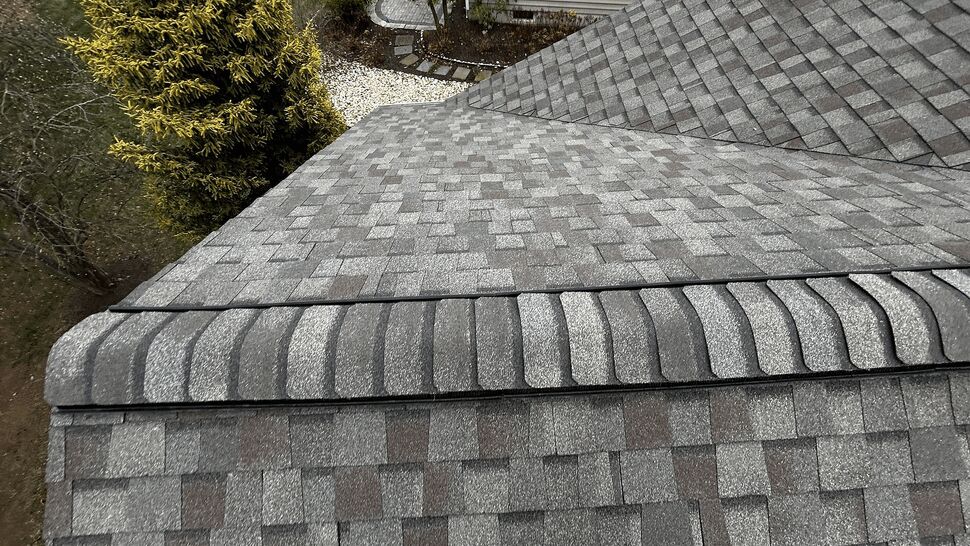 Close-up of ridge cap shingles along the roof peak