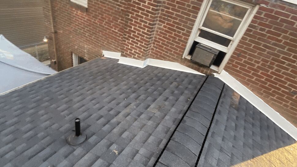 Roof valley near chimney with white metal flashing