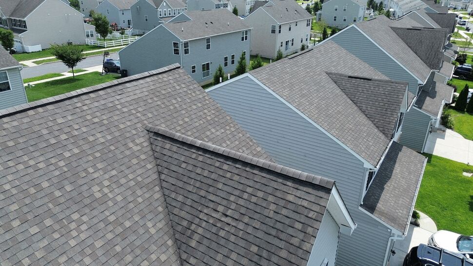 Angled aerial view of multiple homes showing shingle rooflines