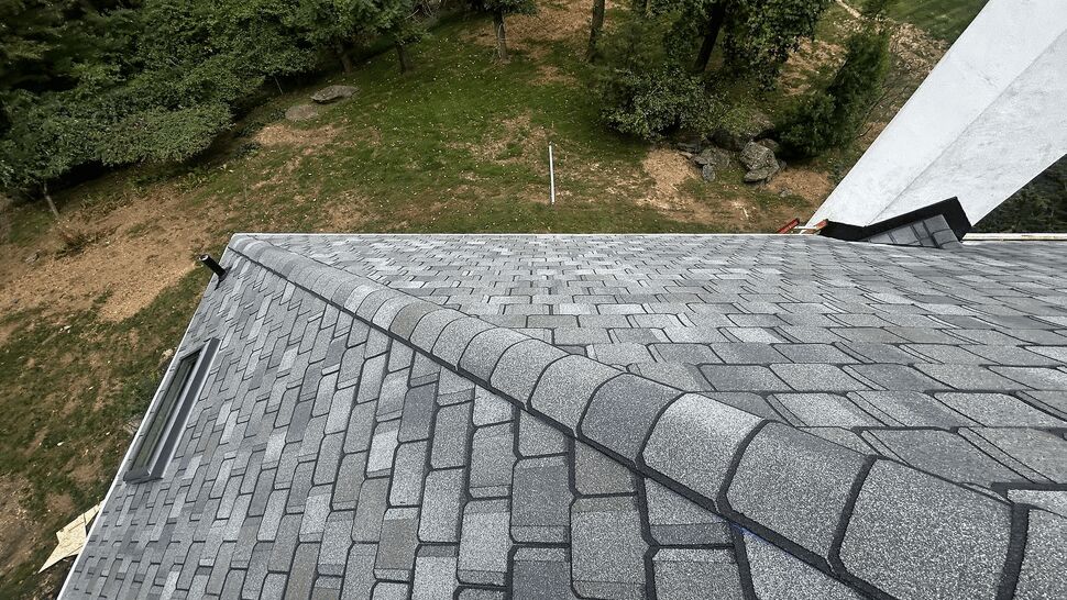 Close-up of shingle pattern and ridge cap on residential roof