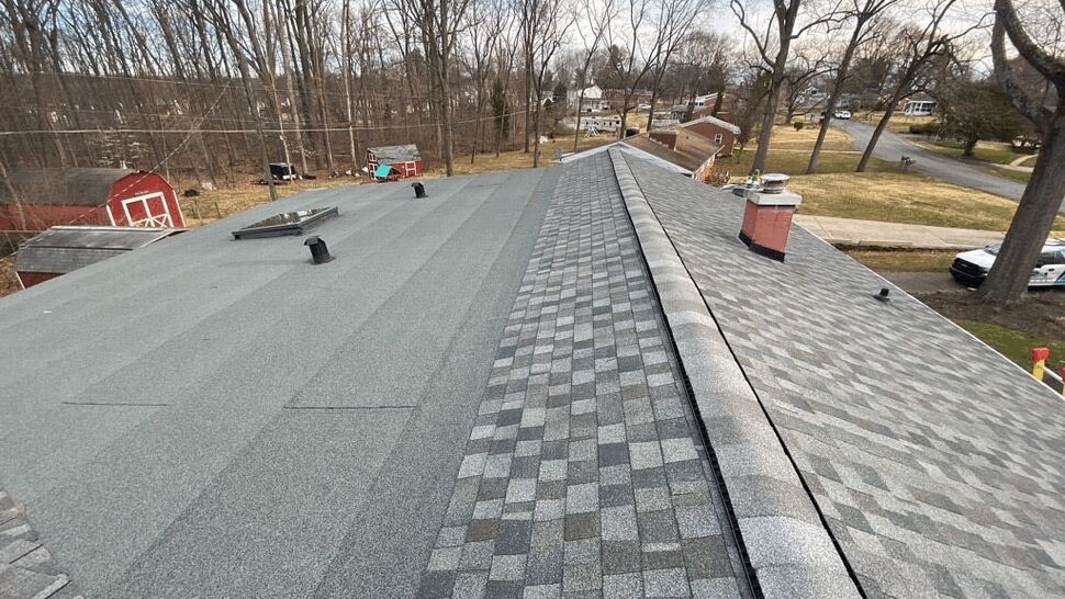 Aerial view showing transition between roll roofing and architectural shingles