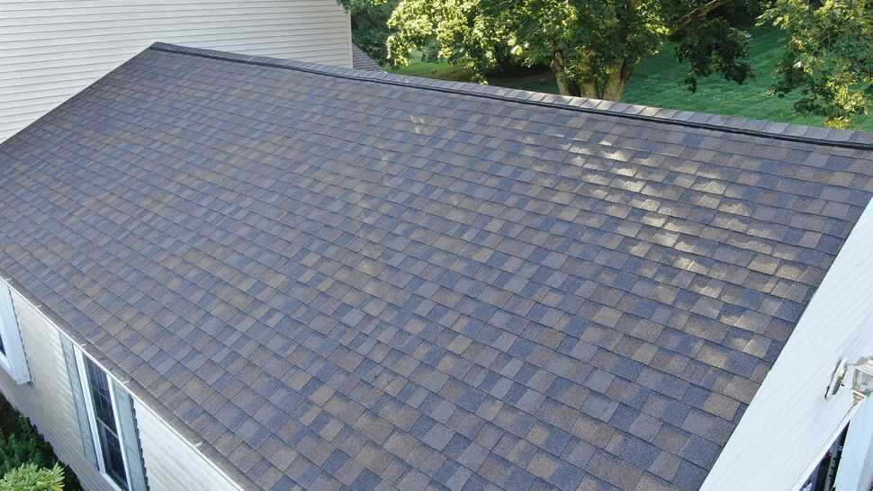 Aerial view of brown asphalt shingle roof on a single-story addition