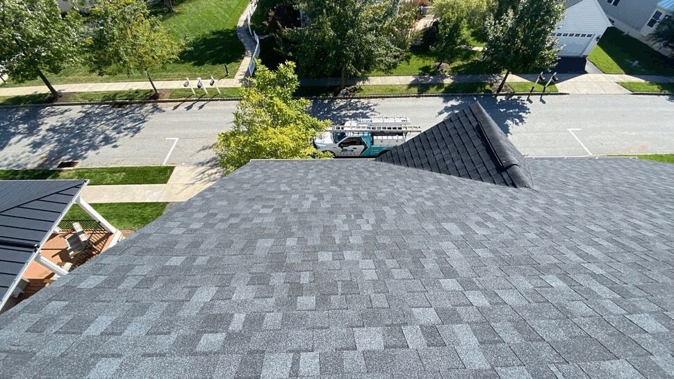 Close aerial shot of textured asphalt shingles on a roof